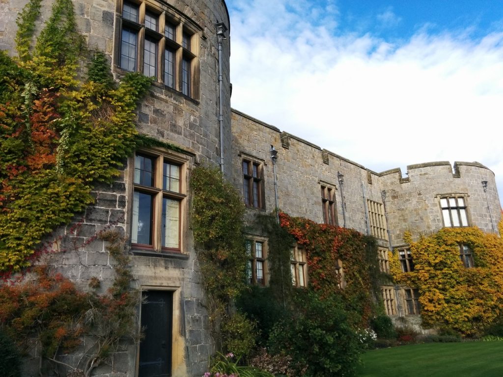 Chirk castle with lots of foliage growing up its walls