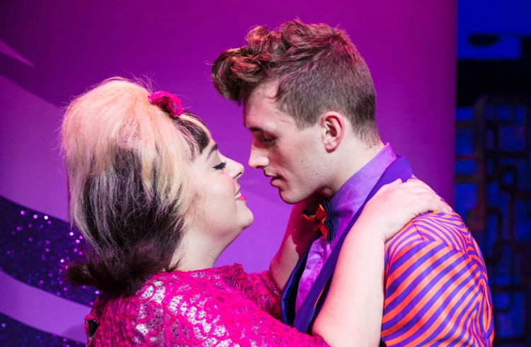 Two members of the cast on stage during a performance of Hairspray the Musical