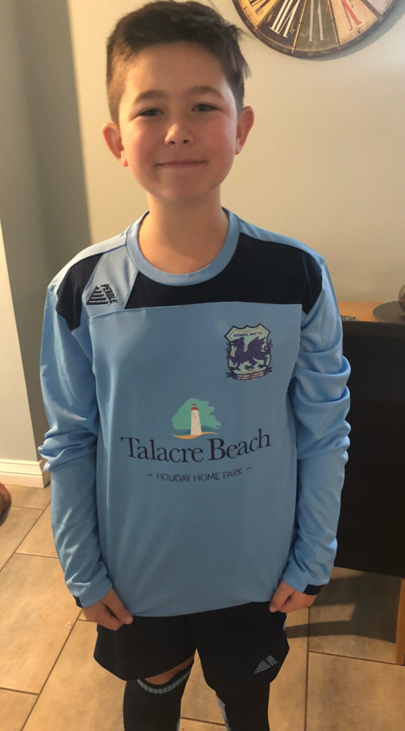 Oliver Roberts wearing his football kit that Talacre Beach Resort sponsored