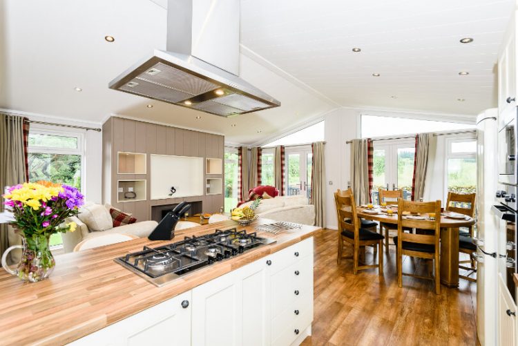 wooden effect flooring in the lounge/kitchen showing the overhead extractor fan