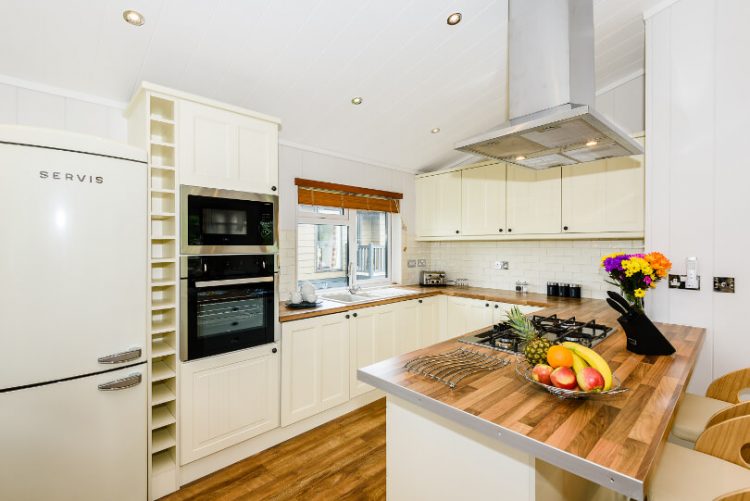 kitchen area with fridge/freezer, kitchen island and kitchen worktops