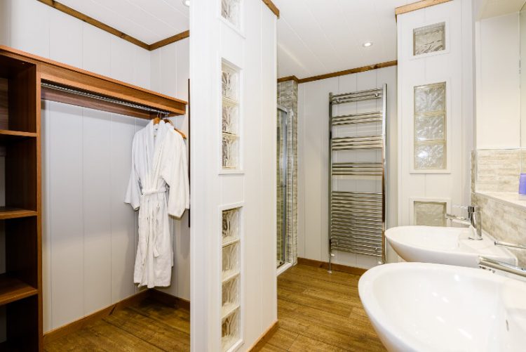 bathroom with tower rail and dressing gown hanging