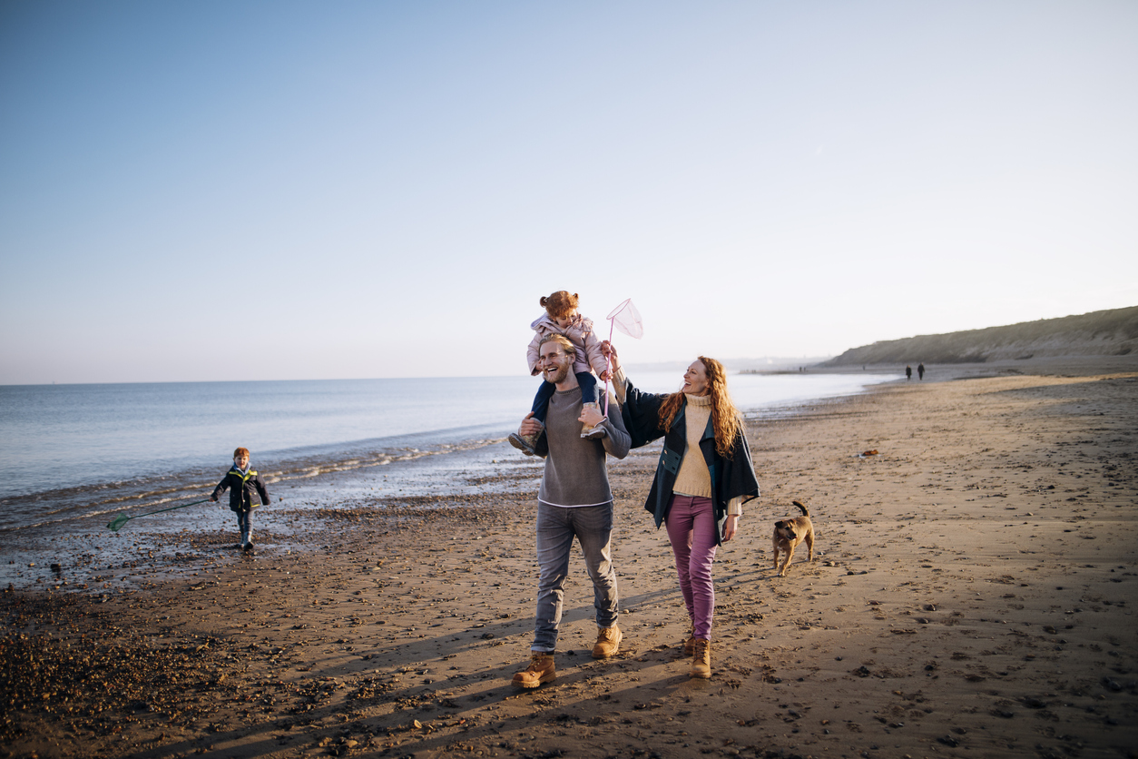 Family walking along the beach front