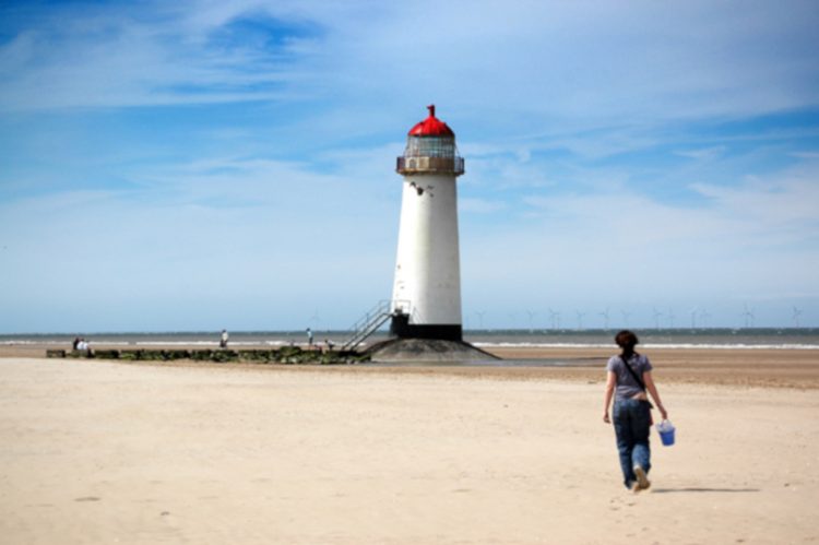 woman walking by the Talacre lighthouse