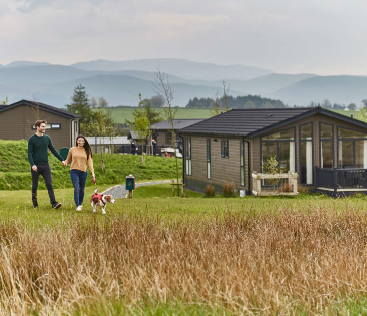 Young couple walking the dog at Keswick Reach Lodge Retreat