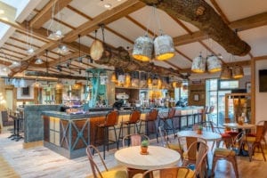 interior of bar with rustic styling and tables in restaurant area