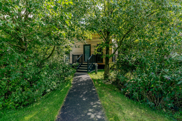 hidden Buxton lodge covered in trees