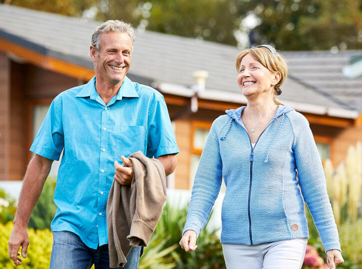 senior couple enjoying a walk around resort