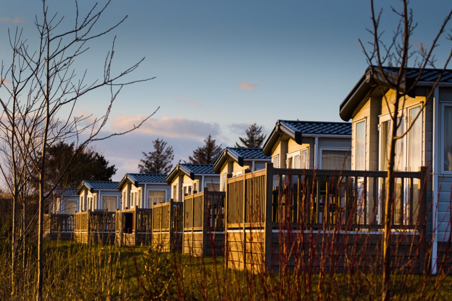 Row of caravans with balconcies at dusk