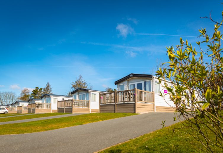 row of caravans with decking in the sunshine