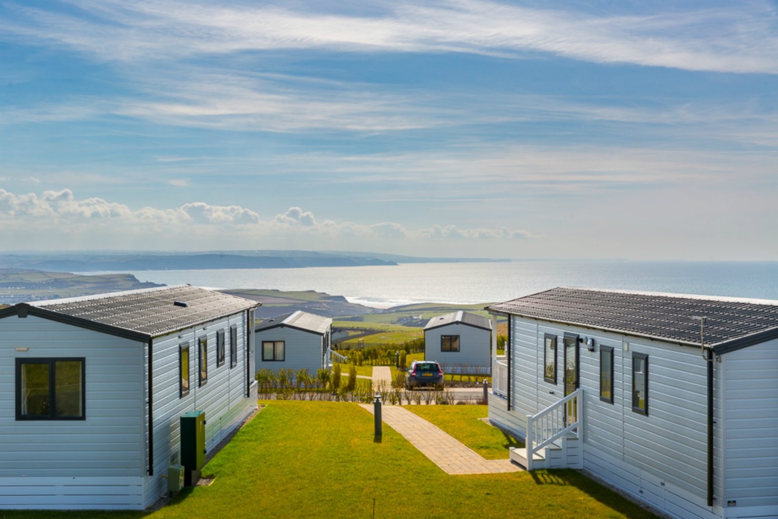 A view through the caravans towards the sea on a sunny day at Sandymouth