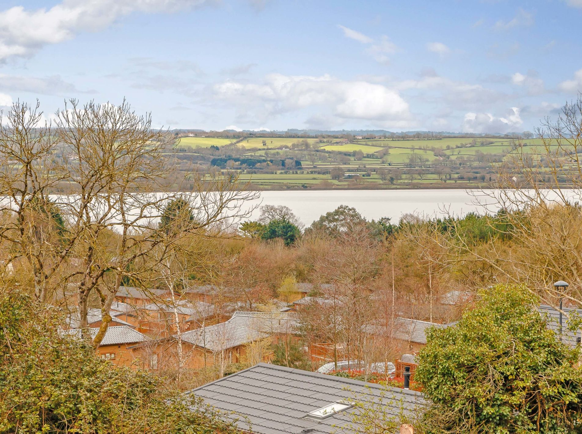 A view over the tops of the lodges at Cheddar Woods and of the countryside