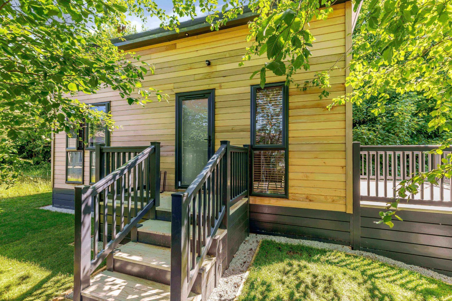 Exterior shot of one of wood clad lodges at Rivendale