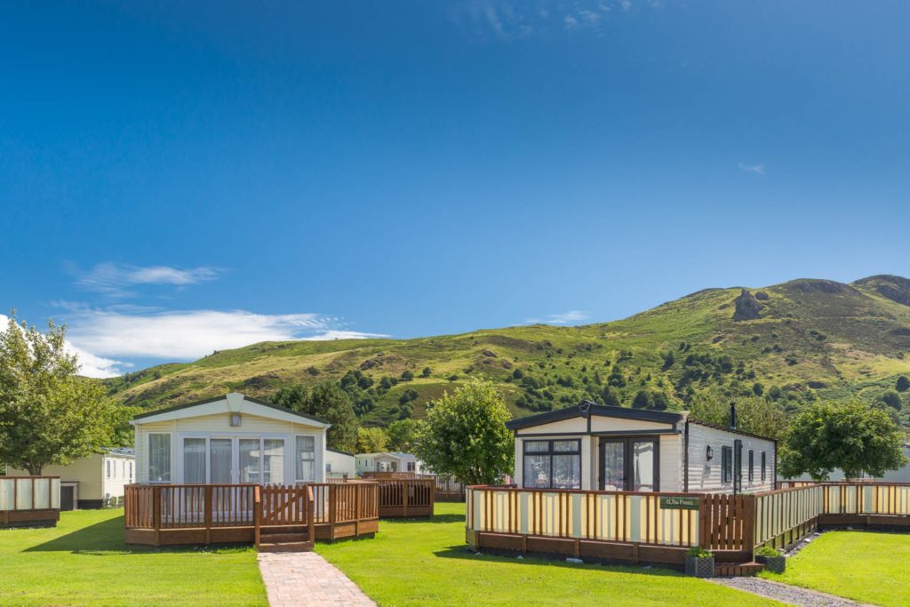 TWO CARAVANS with decking bit in front of a mountain