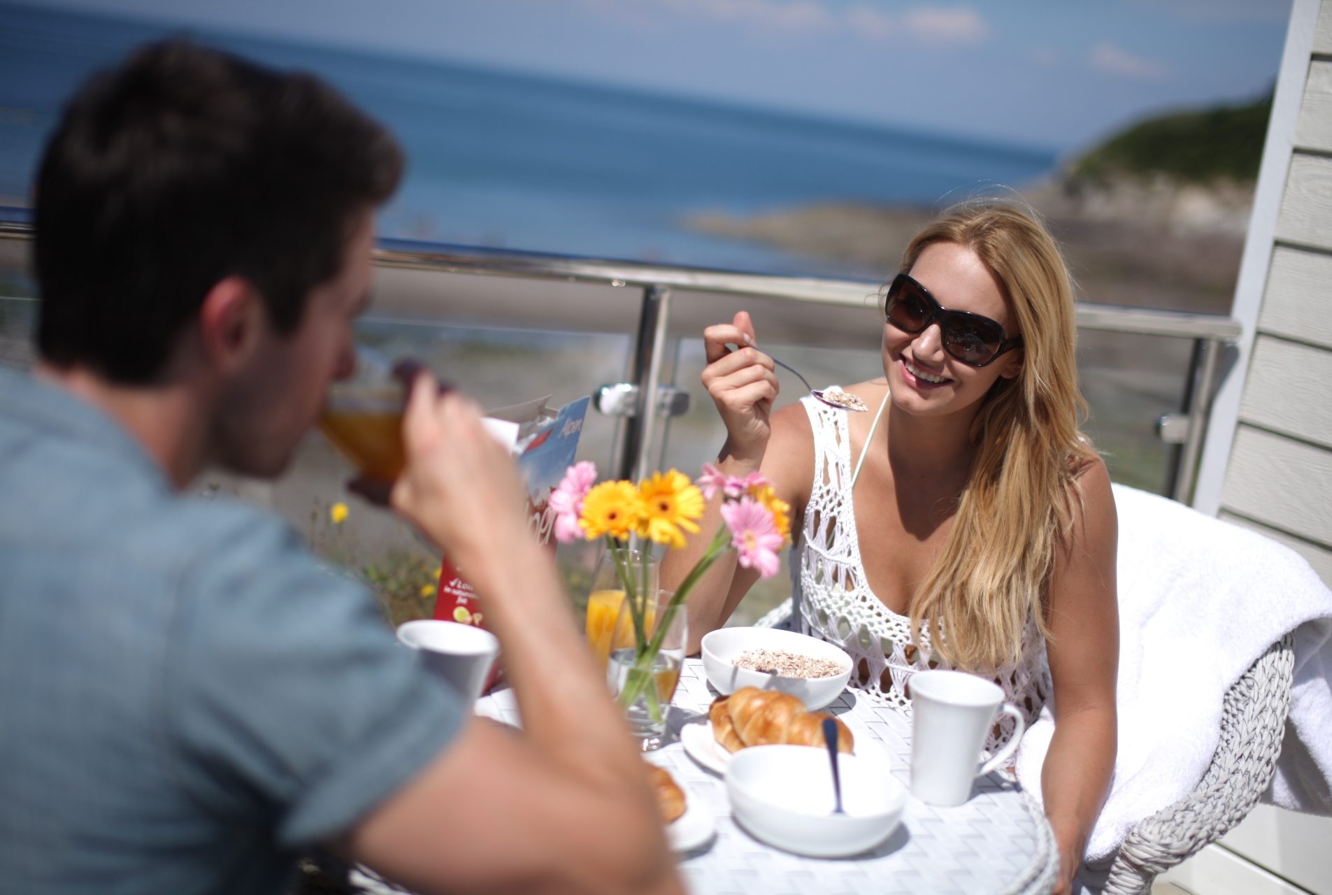 alfresco breakfast besides a beach hut with the sea in the background