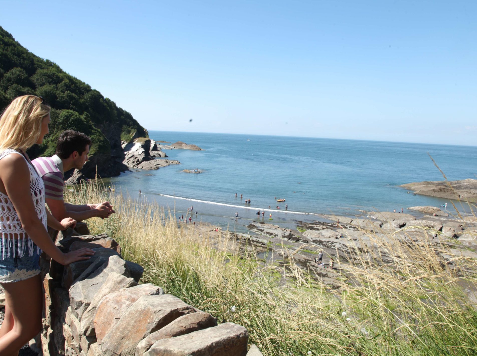 man and woman overlooking the sea