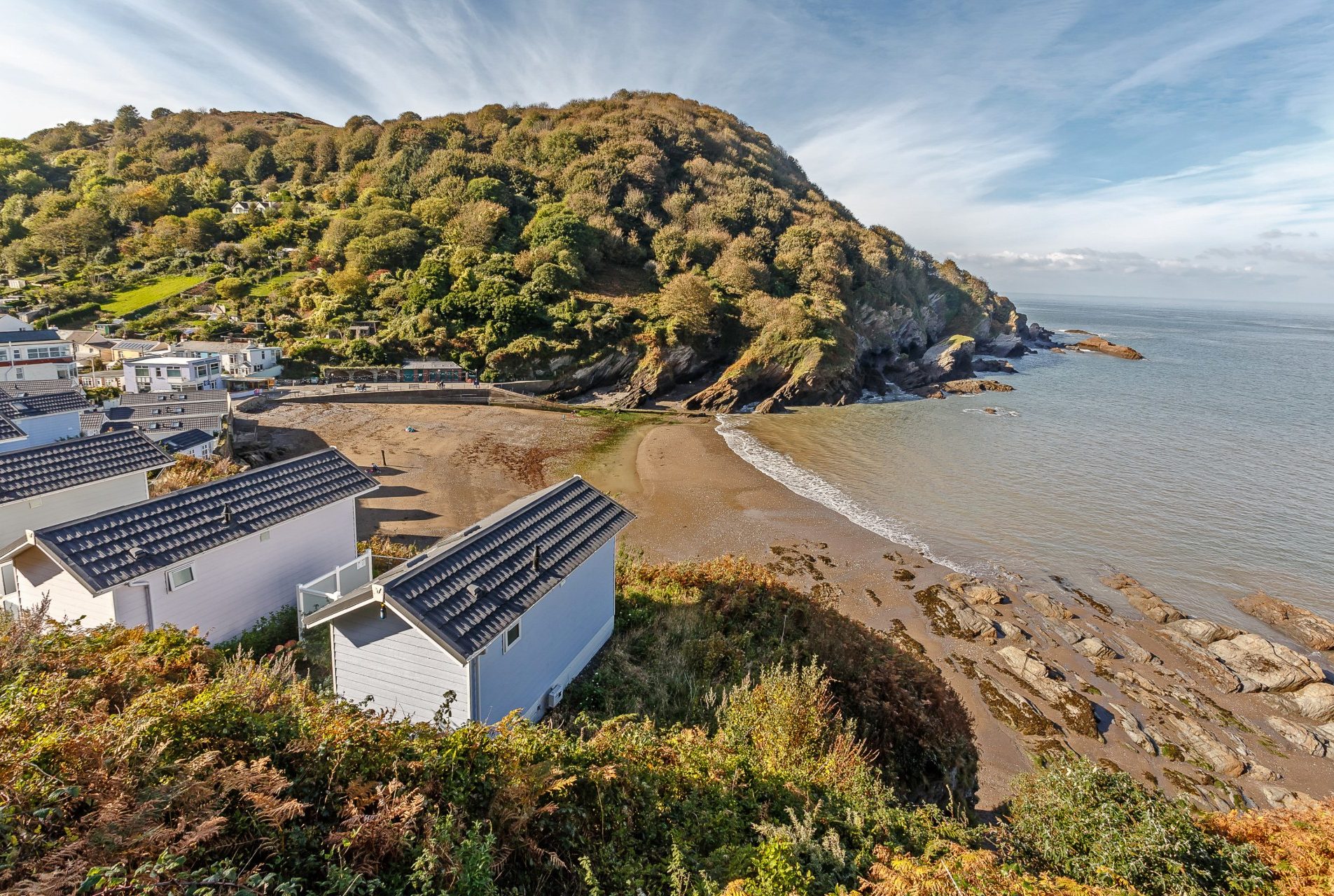 View above hele Bay with beach huts and the cove in view